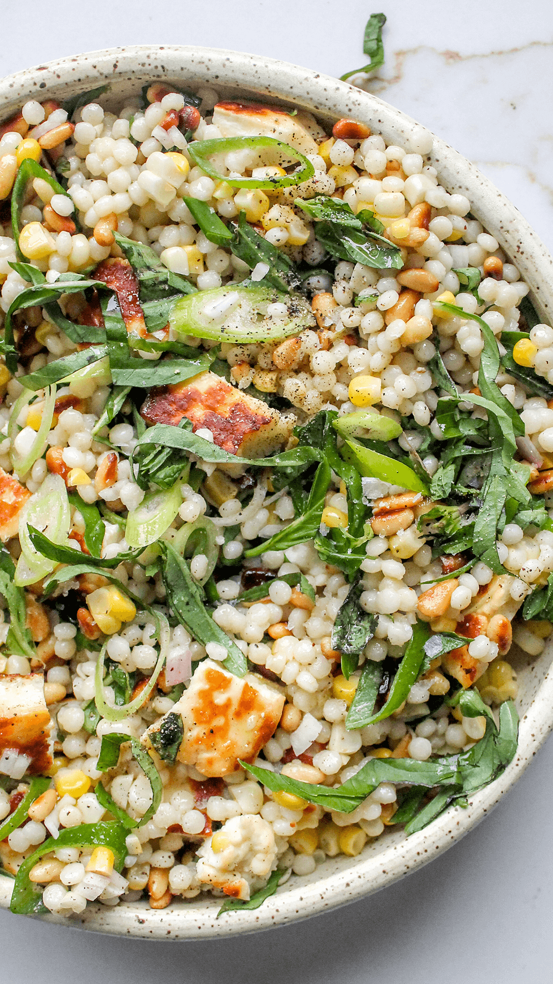 close up bowl of pearl couscous salad