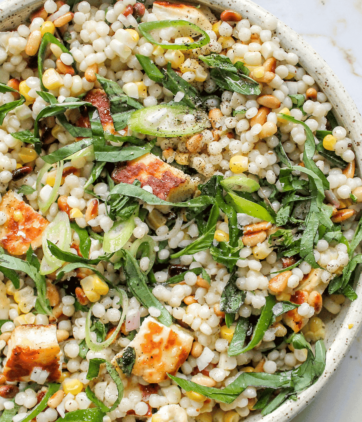 close up bowl of pearl couscous salad