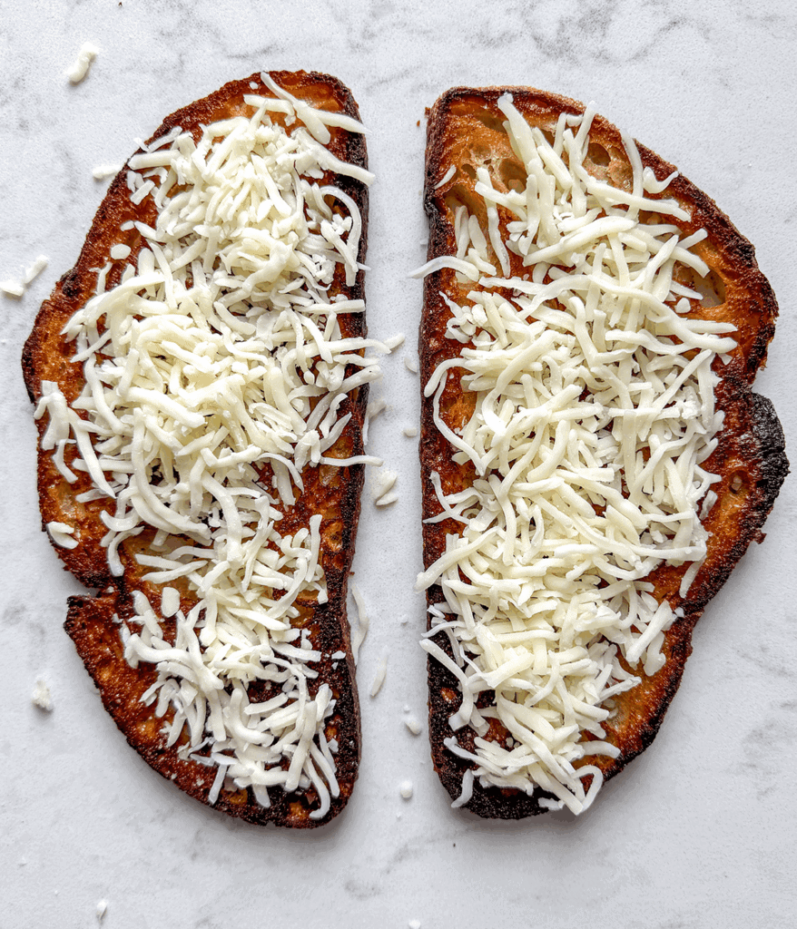 shredded cheese on bread for pizza toast