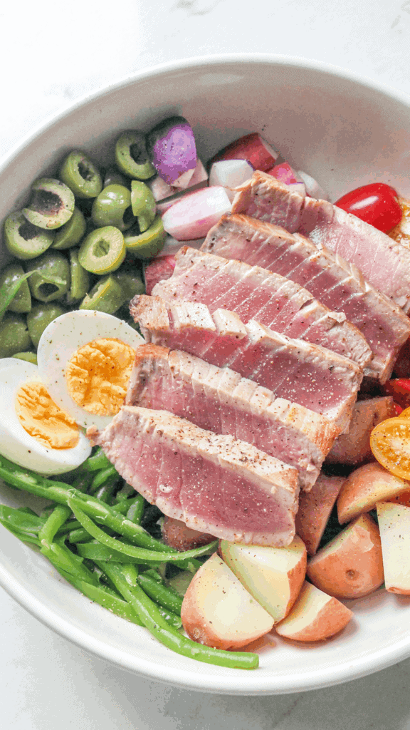 close up of a bowl of nicoise salad
