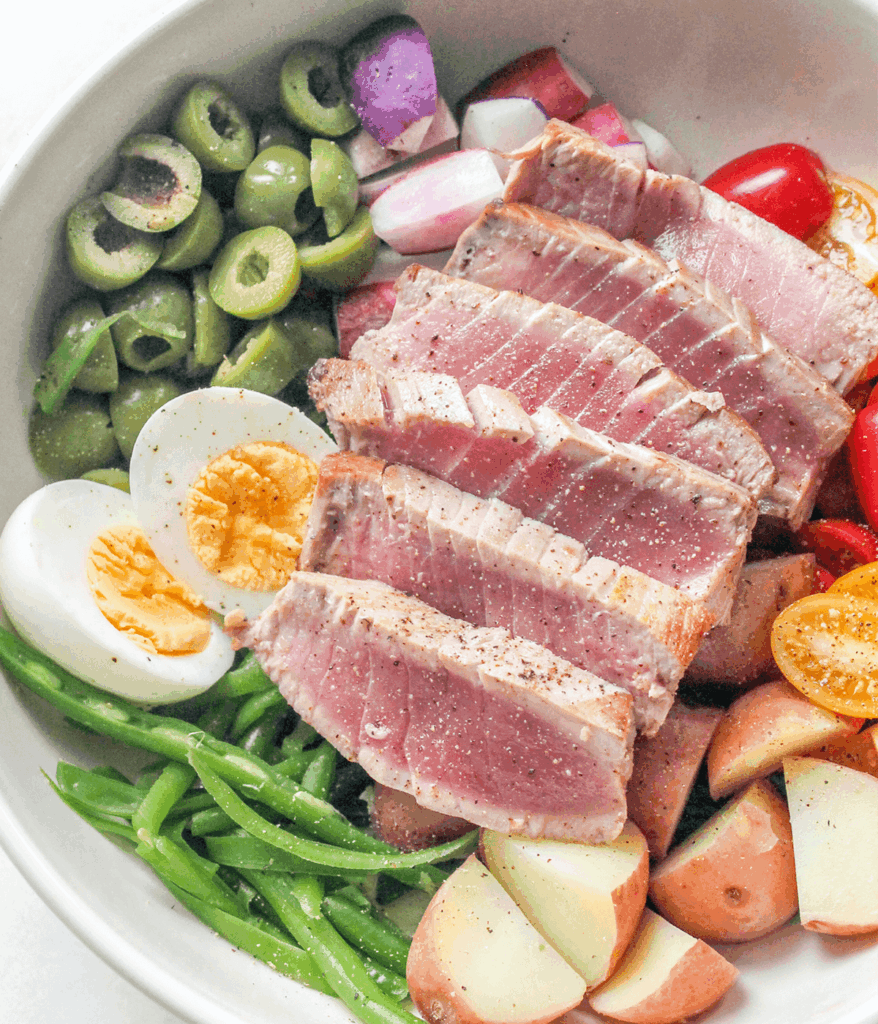 close up of a bowl of nicoise salad