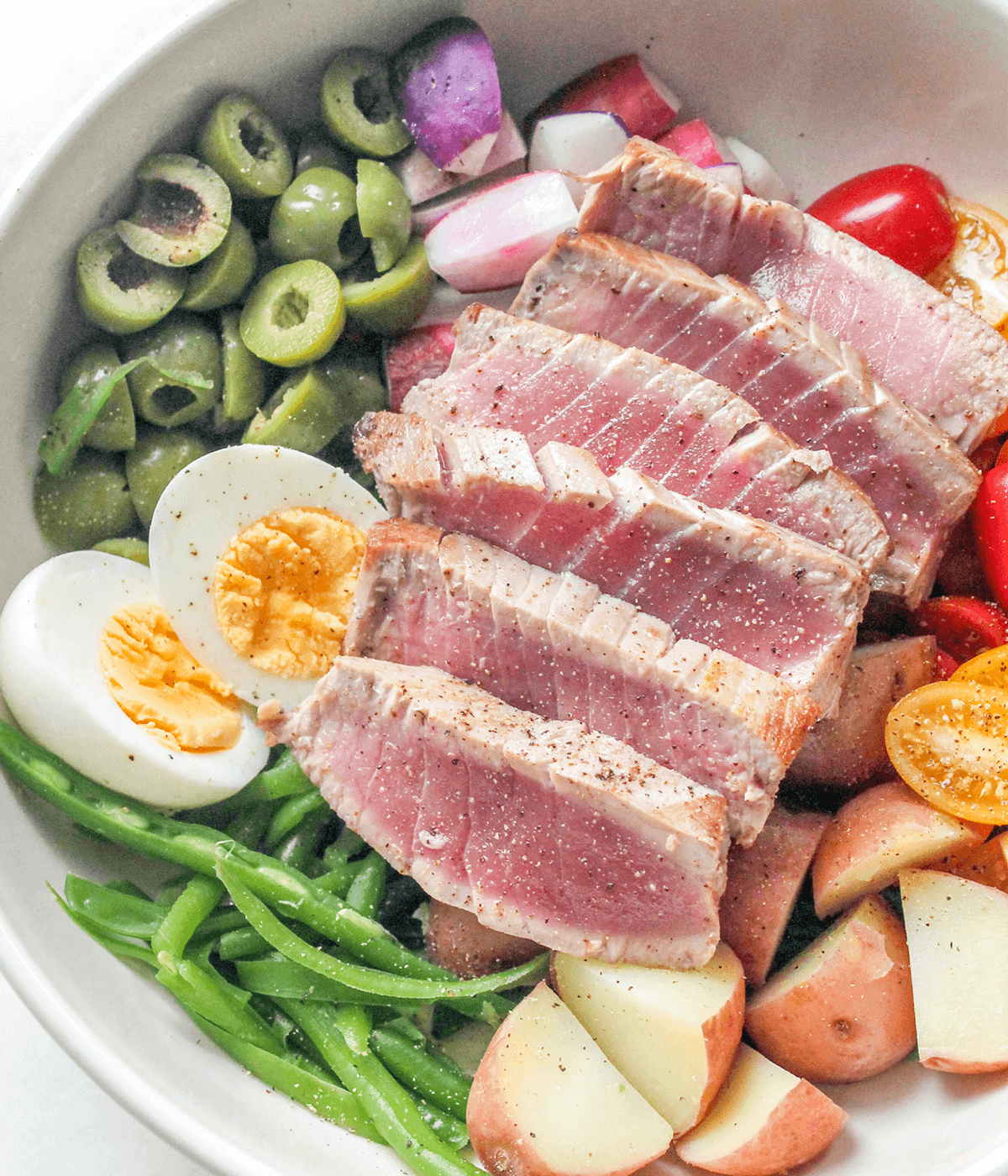 close up of a bowl of nicoise salad
