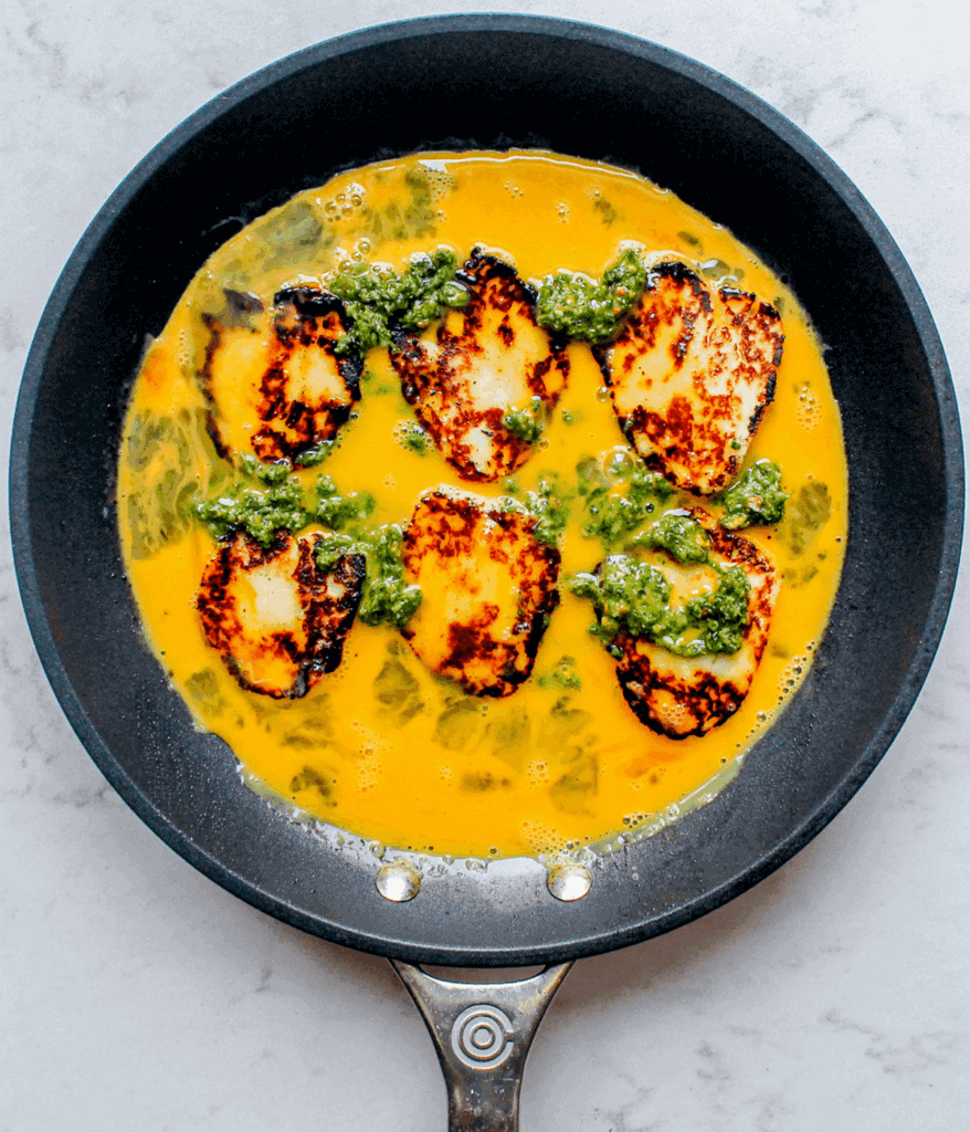 eggs halloumi and pesto in a pan for halloumi egg wrap