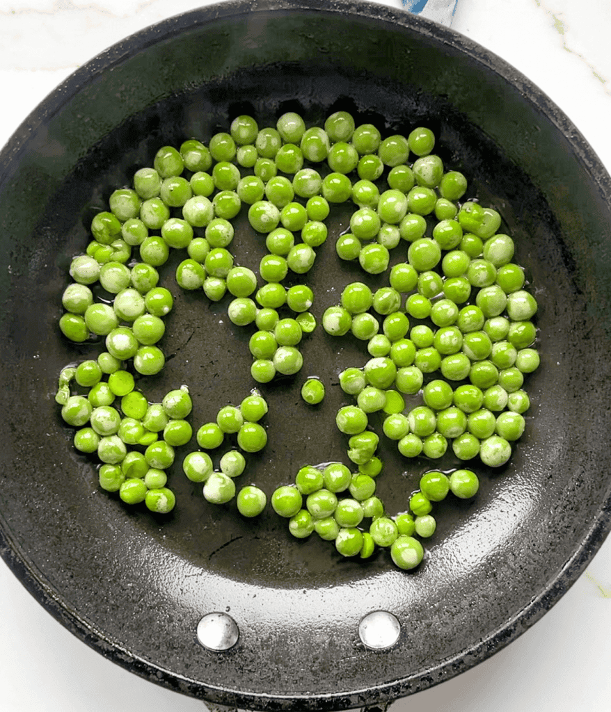 Spring peas in a pan from above