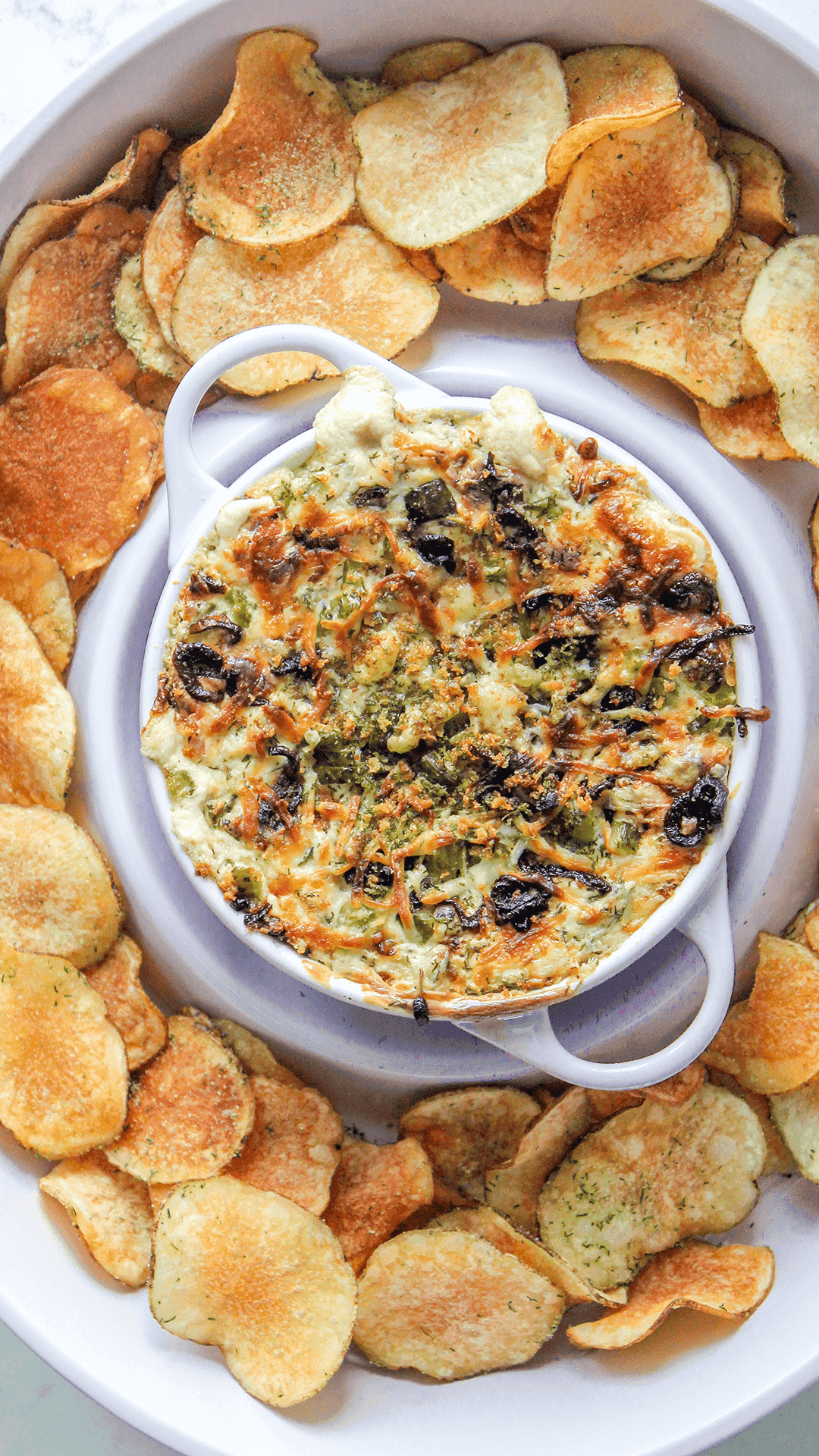pickle dip served with homemade chips in a dip platter
