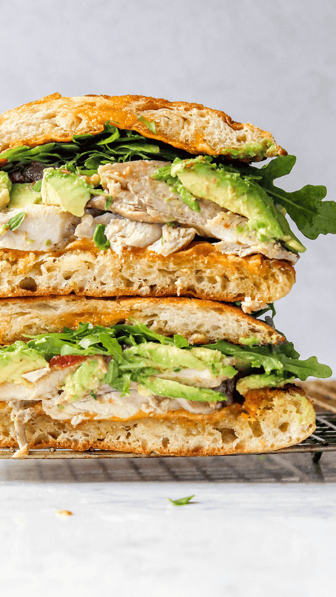 stacked close up of an Avocado, cheddar BBQ chicken sandwich