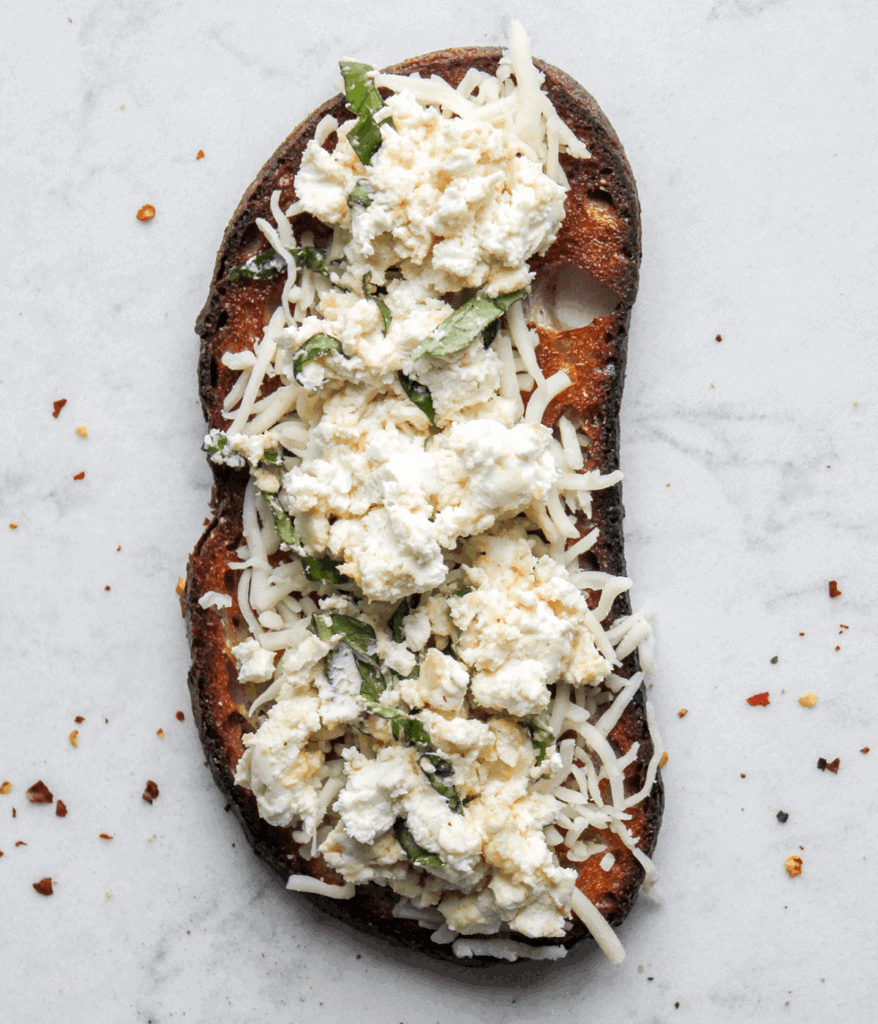 cheese and basil on bread for a goat cheese grilled cheese
