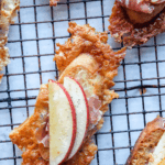 Asiago crusted crostini with apples and prosciutto