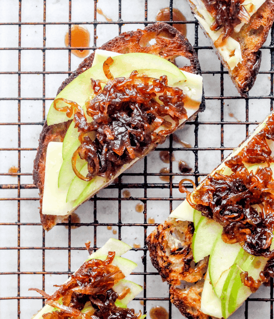 close up of Cheesy Caramelized Onion & Apple Toasts