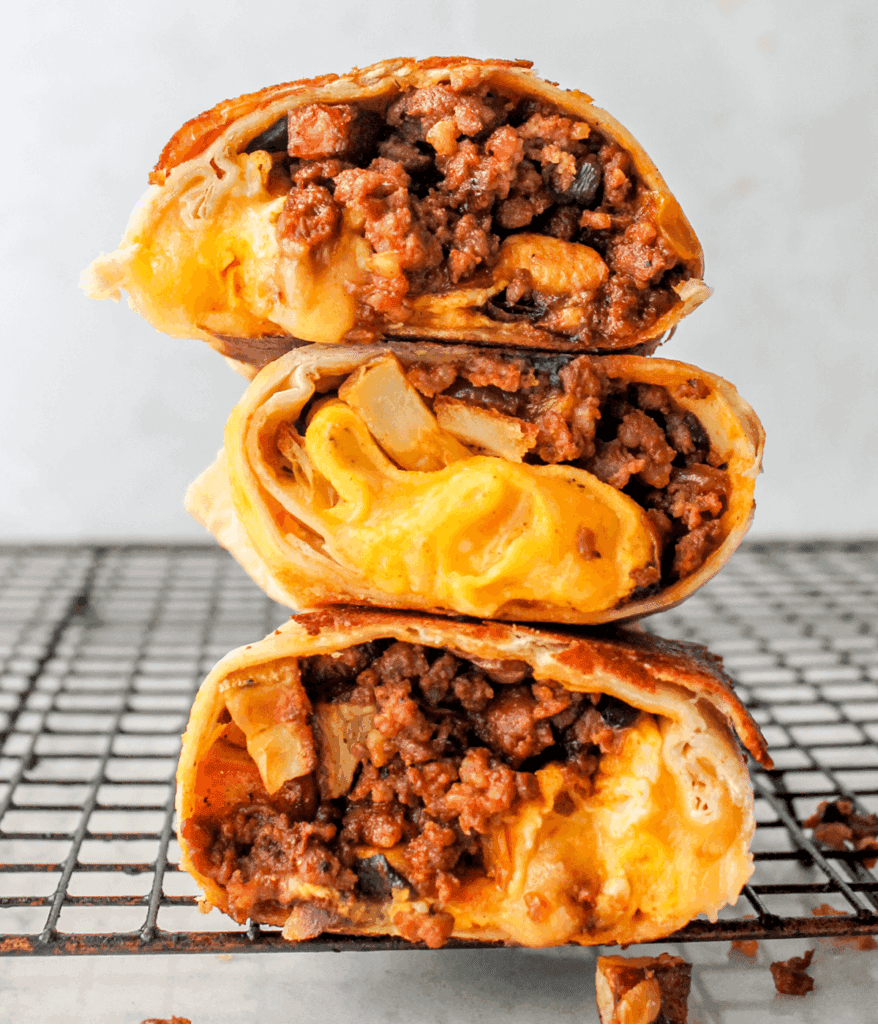 Delicious chorizo breakfast burrito with melted cheese and savory meat filling.