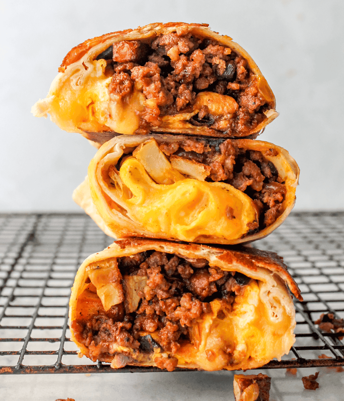 Delicious chorizo breakfast burrito with melted cheese and savory meat filling.