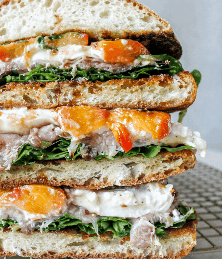 close up stack of peach and burrata sandwich