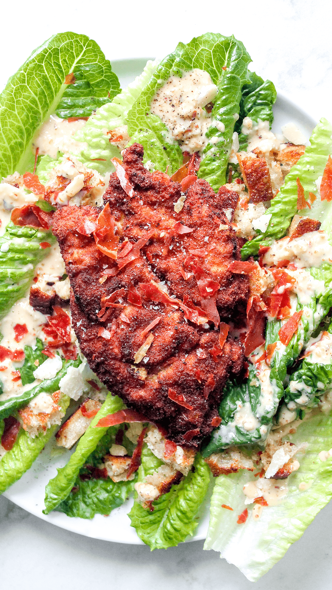 spicy caesar salad with chicken cutlets from above