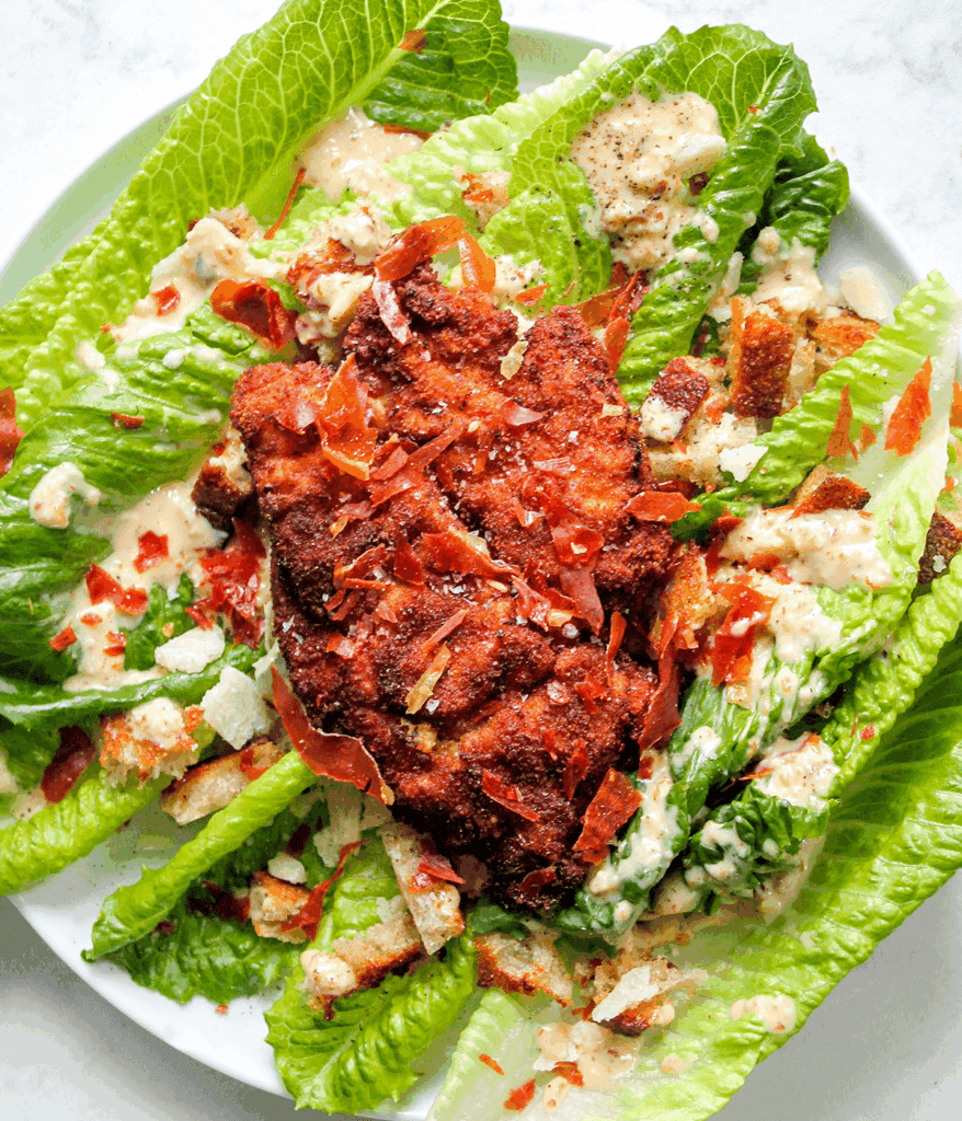 spicy caesar salad with chicken cutlets from above