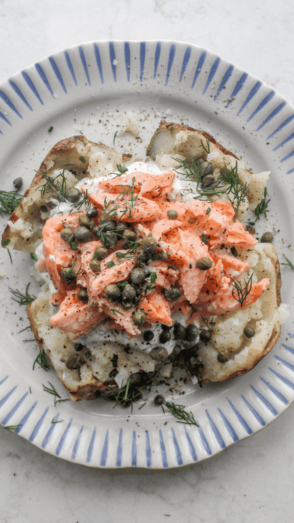 salmon loaded baked potato on a plate