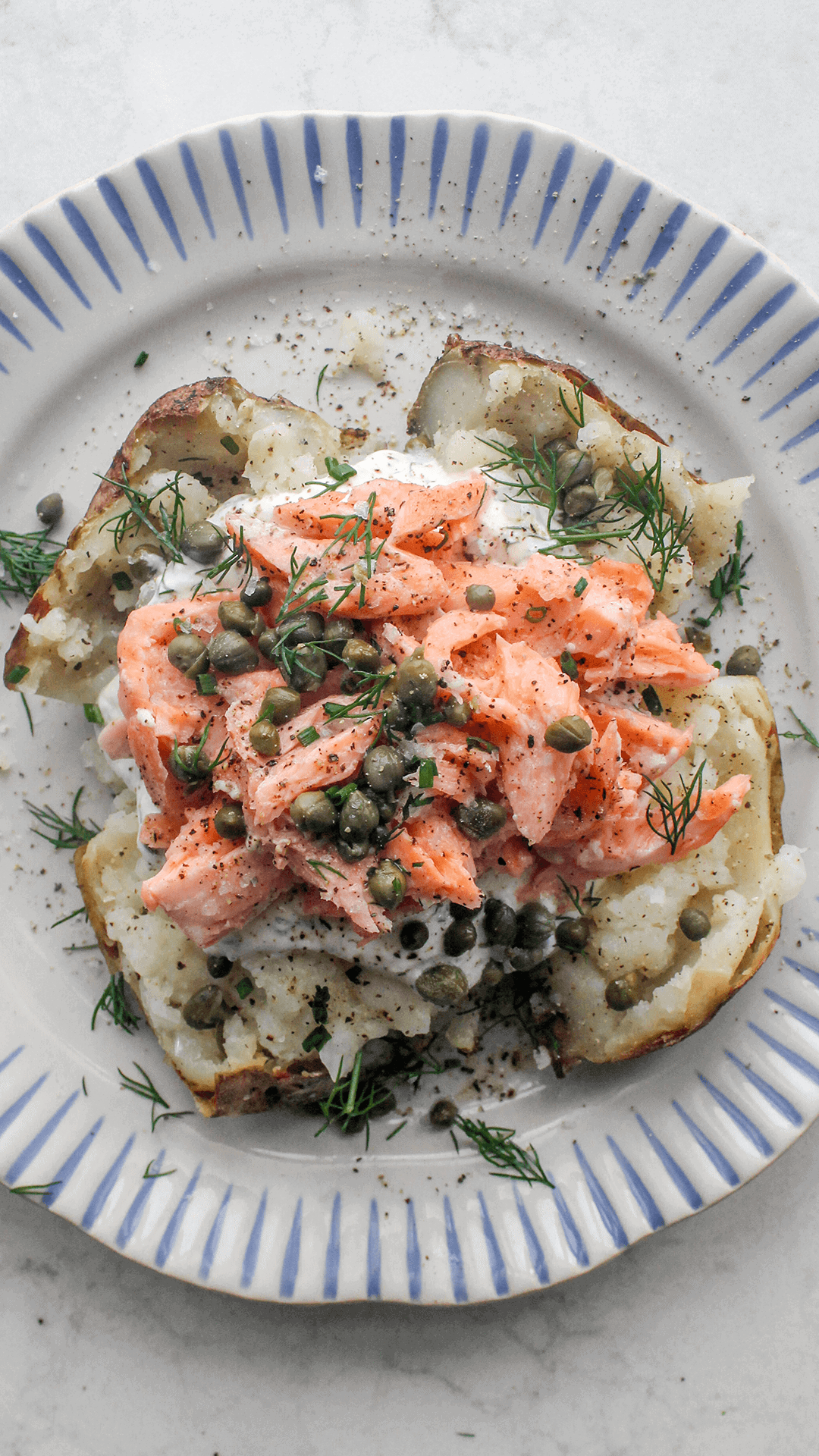 salmon loaded baked potato on a plate