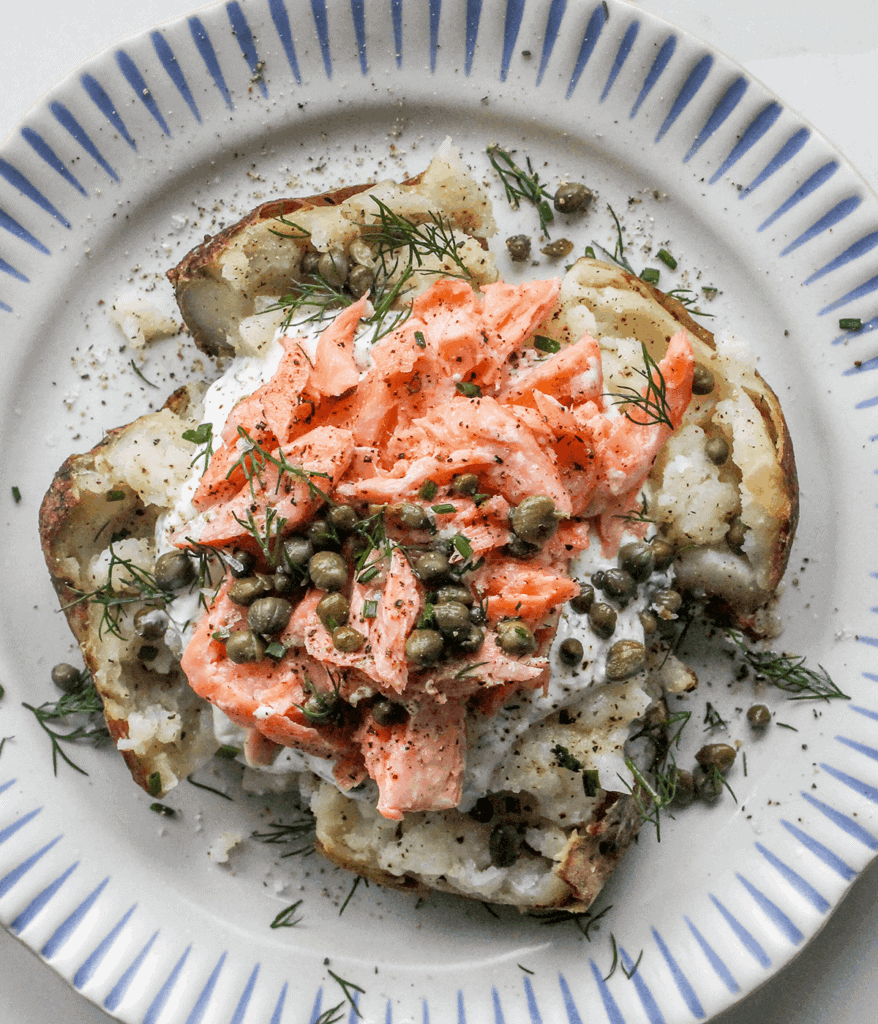 salmon loaded baked potato on a plate