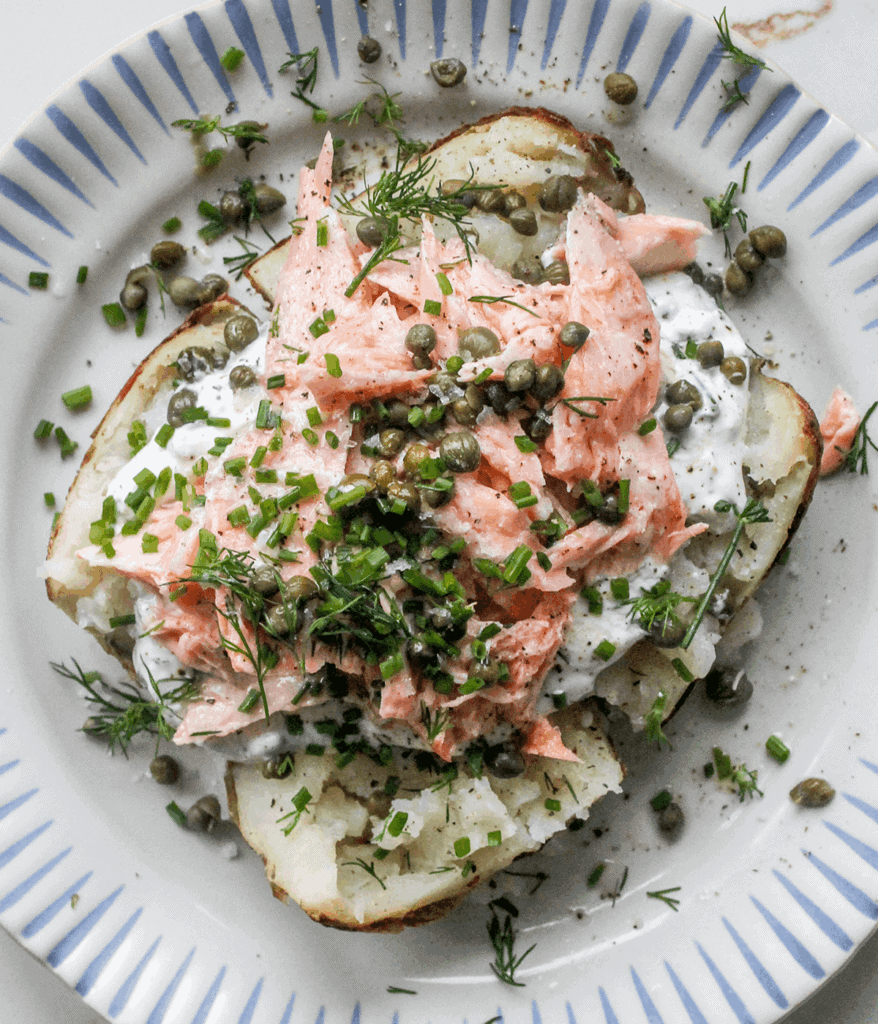 salmon loaded baked potato on a plate